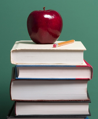 Teachers Apple on Stack of Books with a Pencil