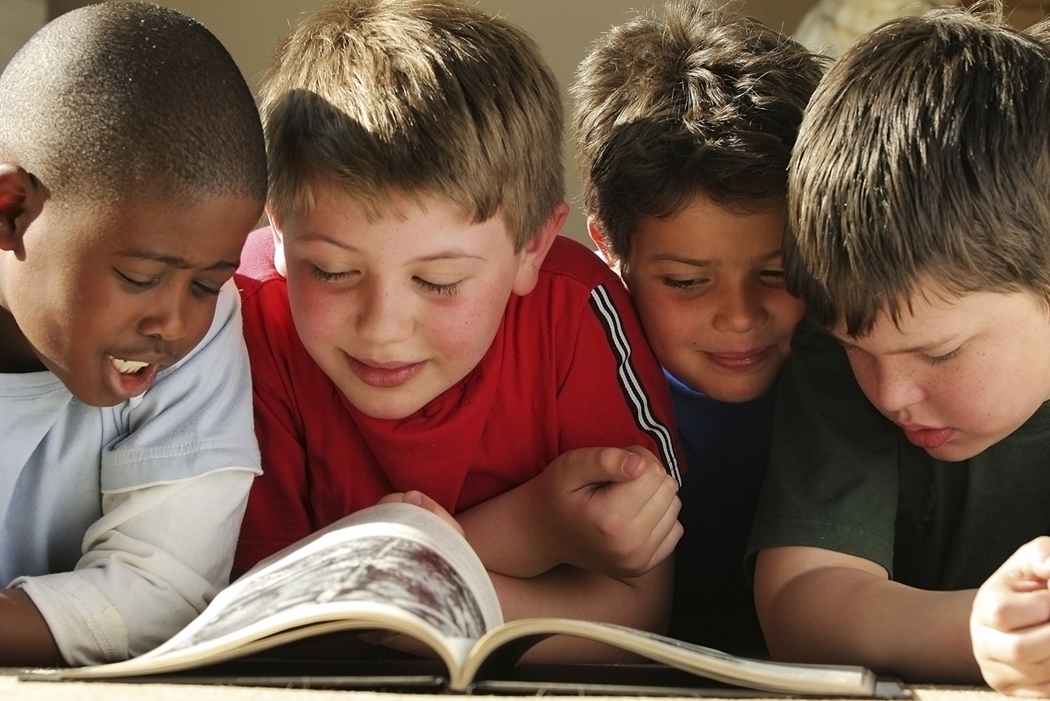 Children Reading a Book Together