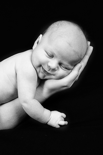 Baby Sleeping in Hands Smiling