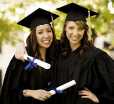 Two women graduating with diplomas in hands