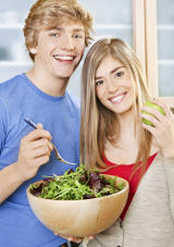 Young Adults Eating Salad Greens